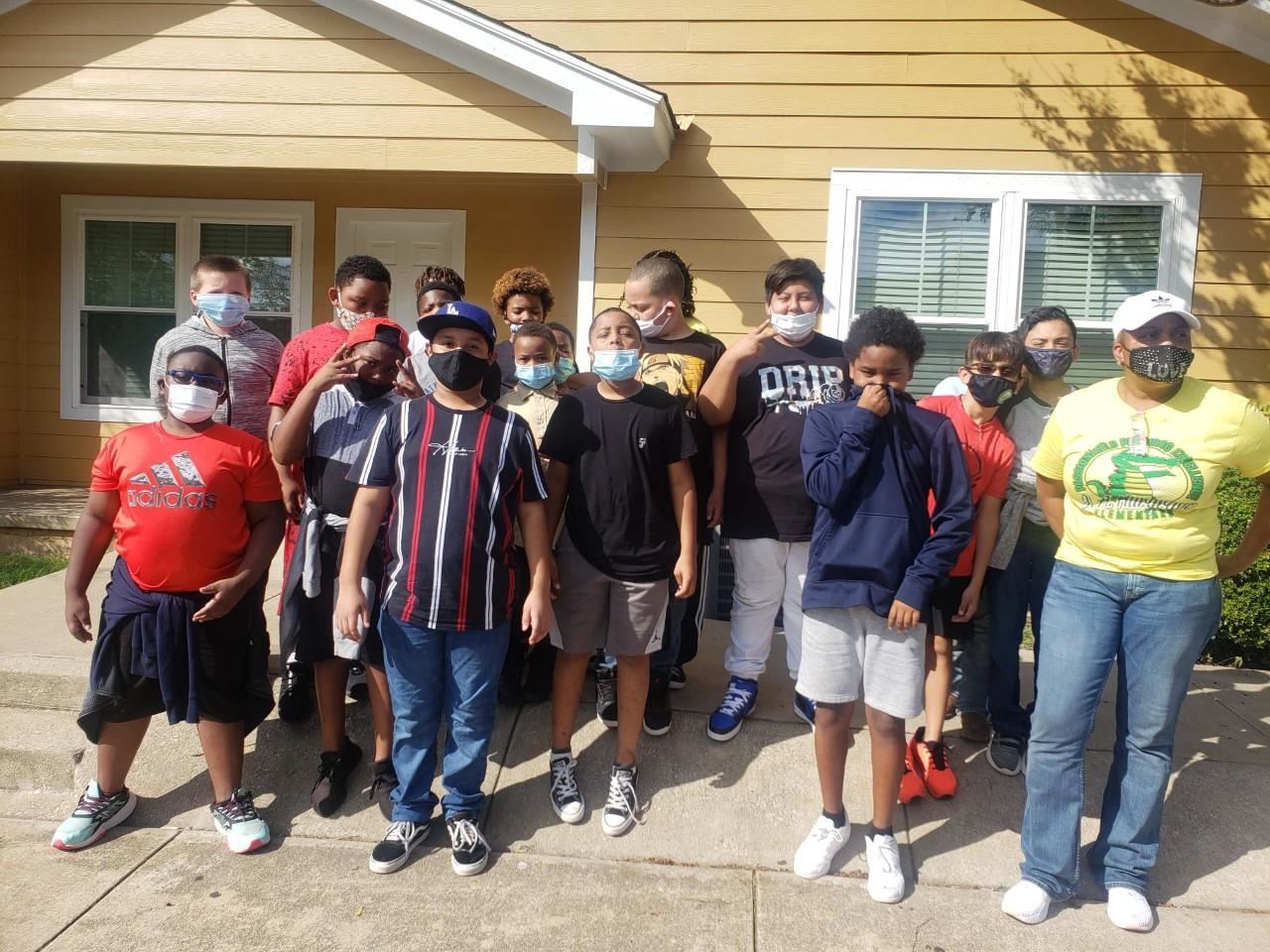 J.A. Hargrave Elementary students in front of a house