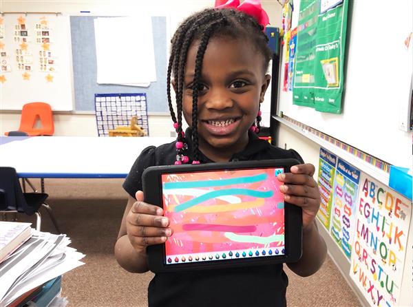 Sy'Mora Kindred holding a paper