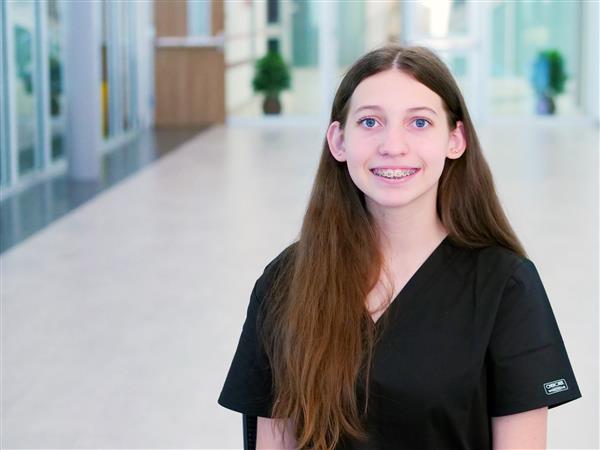 Ava Tinsley smiling in hallway