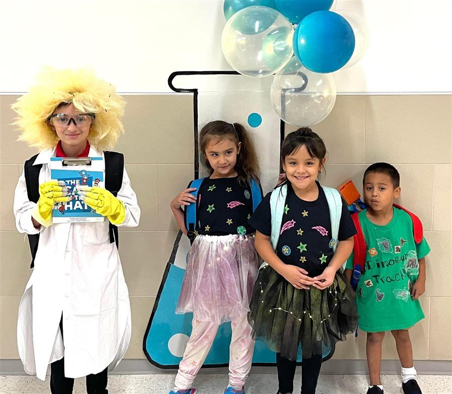 Students posing in front of a drawn beaker