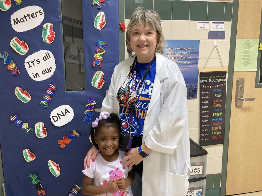 Teacher and student in front of STEM door